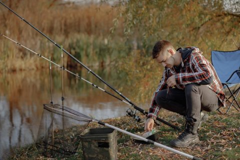An angler fishing for striped bass from the bank.