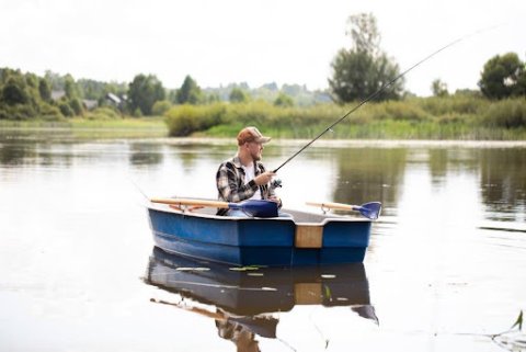 Man Fishing for Bass on a Lake.