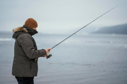 A fisherman equipped with the best gear for winter bass fishing.